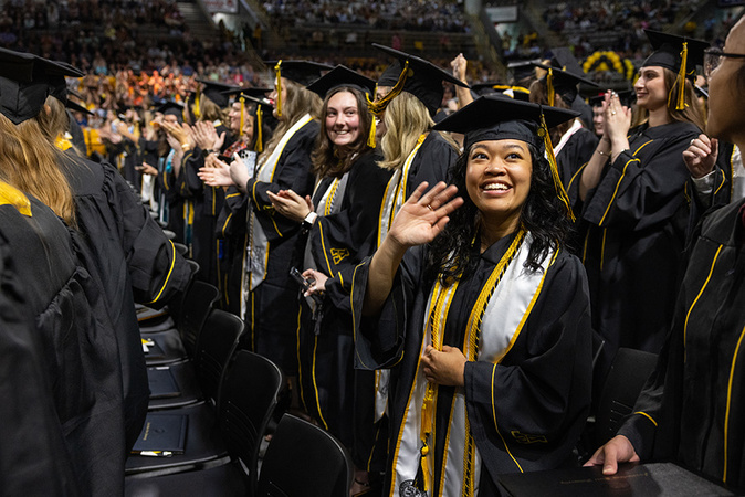 An App State Class of 2025 graduate waves to the crowd during the university’s 1 p.m. Spring 2025 Commencement ceremony for the College of Arts and Sciences, held May 9. 