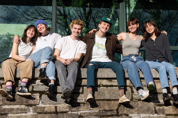 Campus scene of students on rock wall